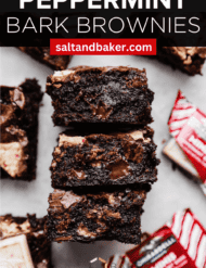 Brownies with peppermint bark cut in squares on marble background with the words, "Peppermint Bark Brownies" written in white text above the photo.