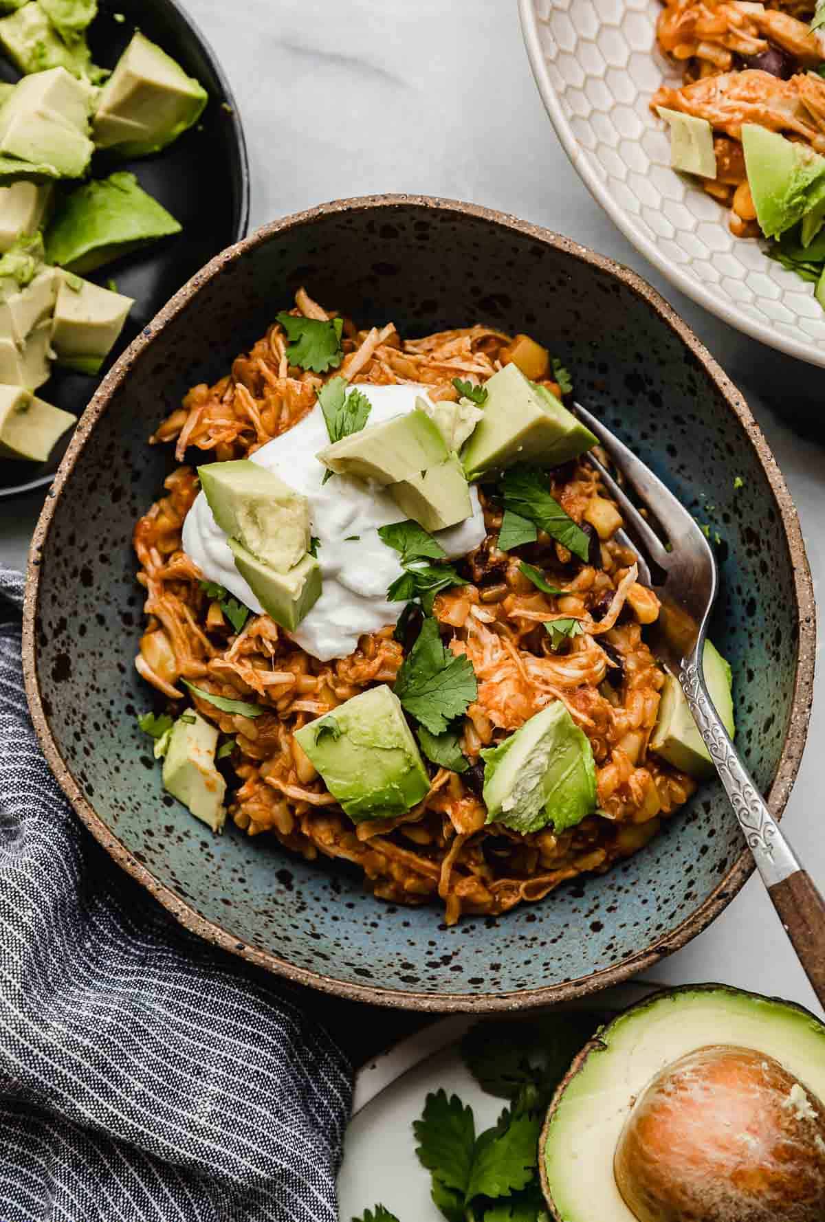 A blue bowl filled with shredded chicken taco bowls made in the instant pot.