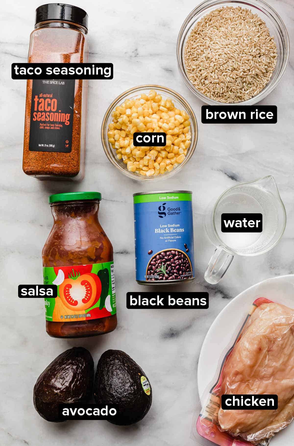 Instant Pot Chicken Taco Bowls ingredients on a white background: black beans, salsa, taco seasoning, chicken, water, corn, and brown rice.