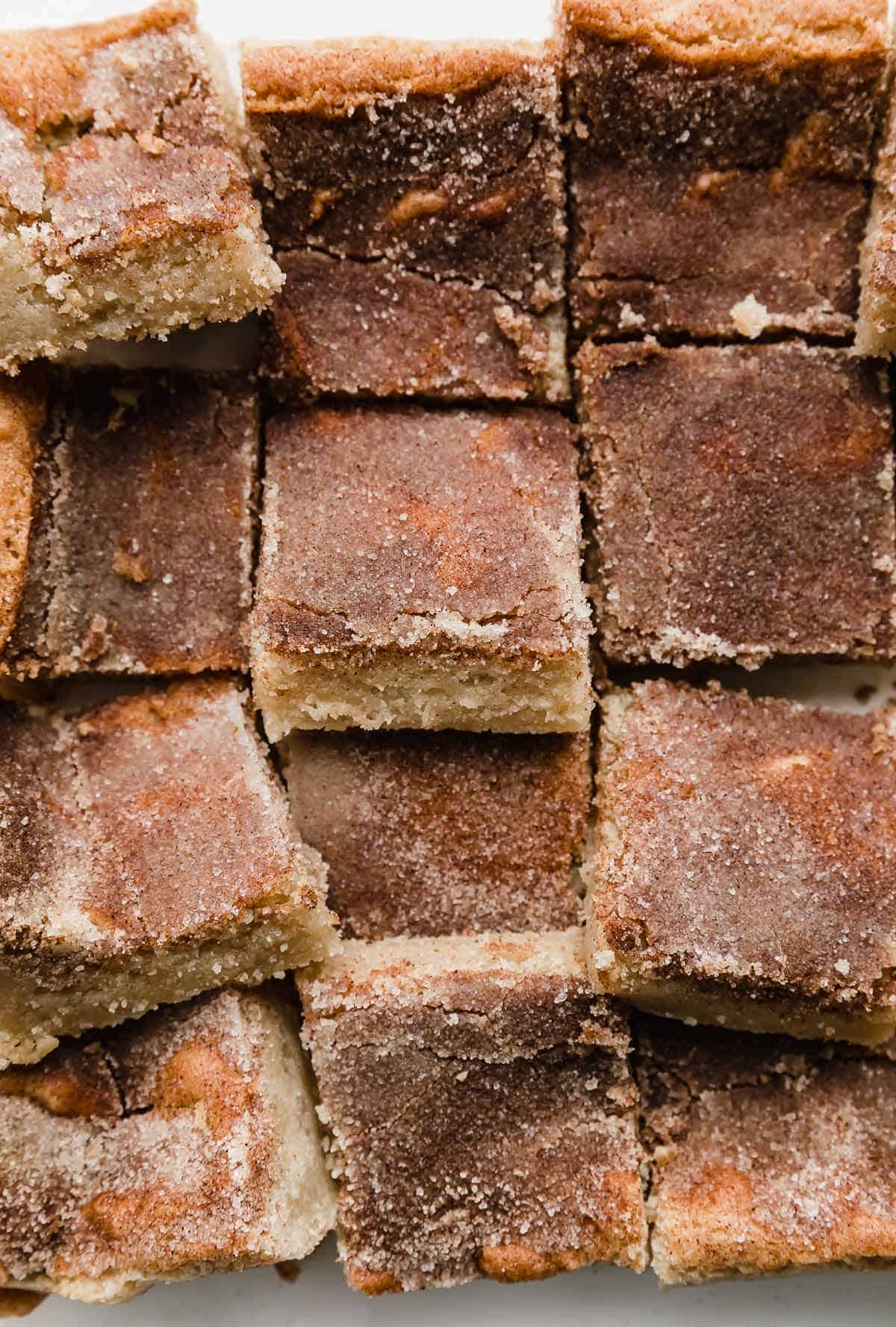 Snickerdoodle Bars recipe topped with cinnamon sugar and cut into squares.