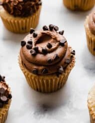 Moist Chocolate Chip Cupcakes made with buttermilk on a white marble table.