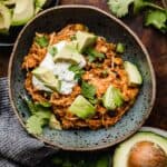 A blue bowl filled with the best chicken taco bowls with brown rice, made in the instant pot.