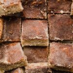 Close up image of Snickerdoodle Bars cut into squares, and topped with cinnamon sugar mixture.