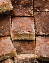 Close up image of Snickerdoodle Bars cut into squares, and topped with cinnamon sugar mixture.