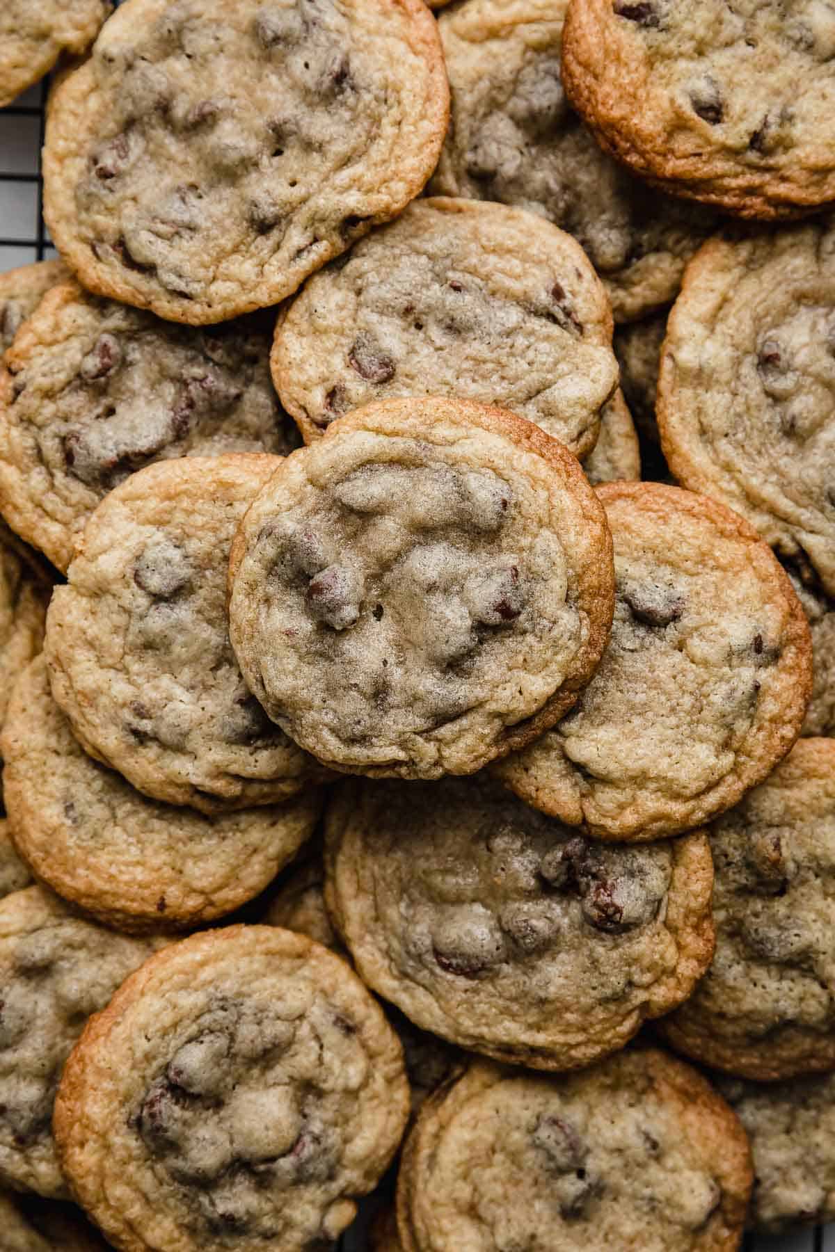 A large pile of Nestle Toll House Chocolate Chip Cookies.