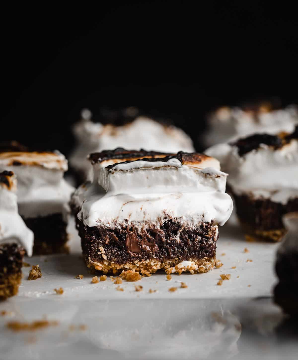 The best S'mores Brownies ever, cut into squares on a white marble surface against a black background.