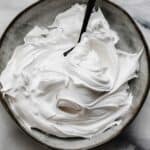 the best Homemade Marshmallow Cream recipe swirled on a gray plate.