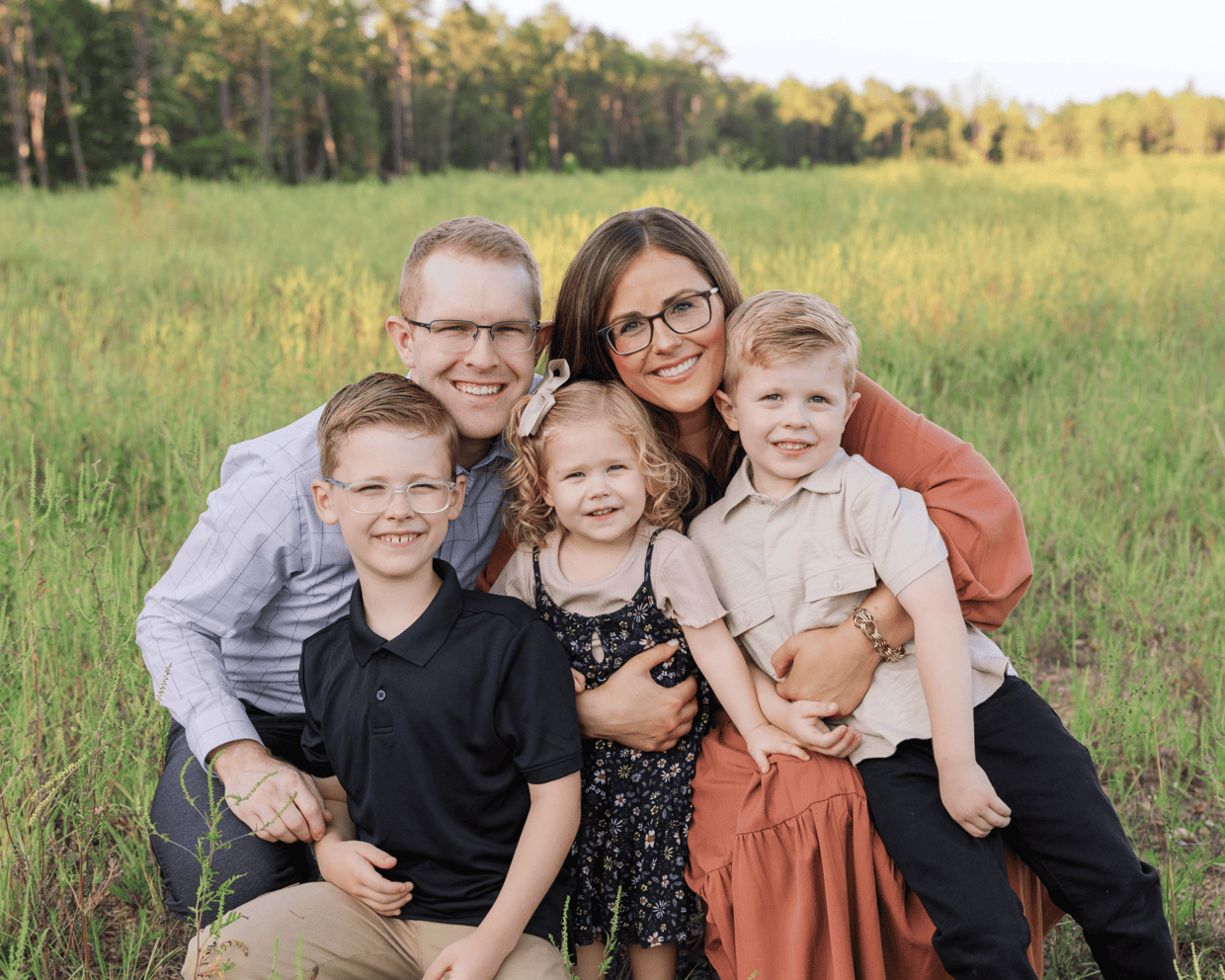 A photo of Whitney Wright from Salt & Baker food blog pictured with her husband and 3 children.
