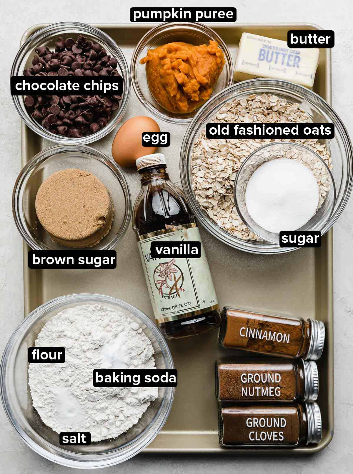 Chocolate Chip Oatmeal Pumpkin Cookies ingredients portioned into glass bowls on silver baking tray.