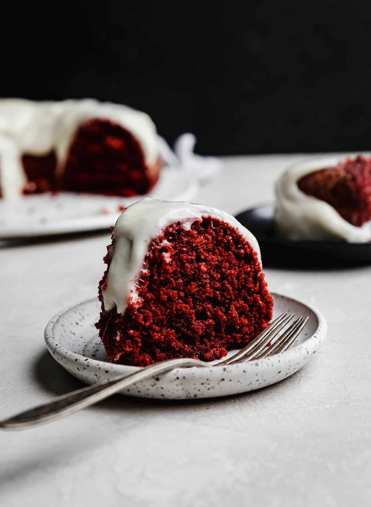 A slice of Red Velvet Bundt Cake on a white plate.