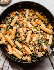 Carrot, onion, celery, and spinach loaded Italian Sausage Rigatoni in a large pot.