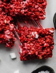 A Red Velvet Rice Krispie treat on a light gray background.