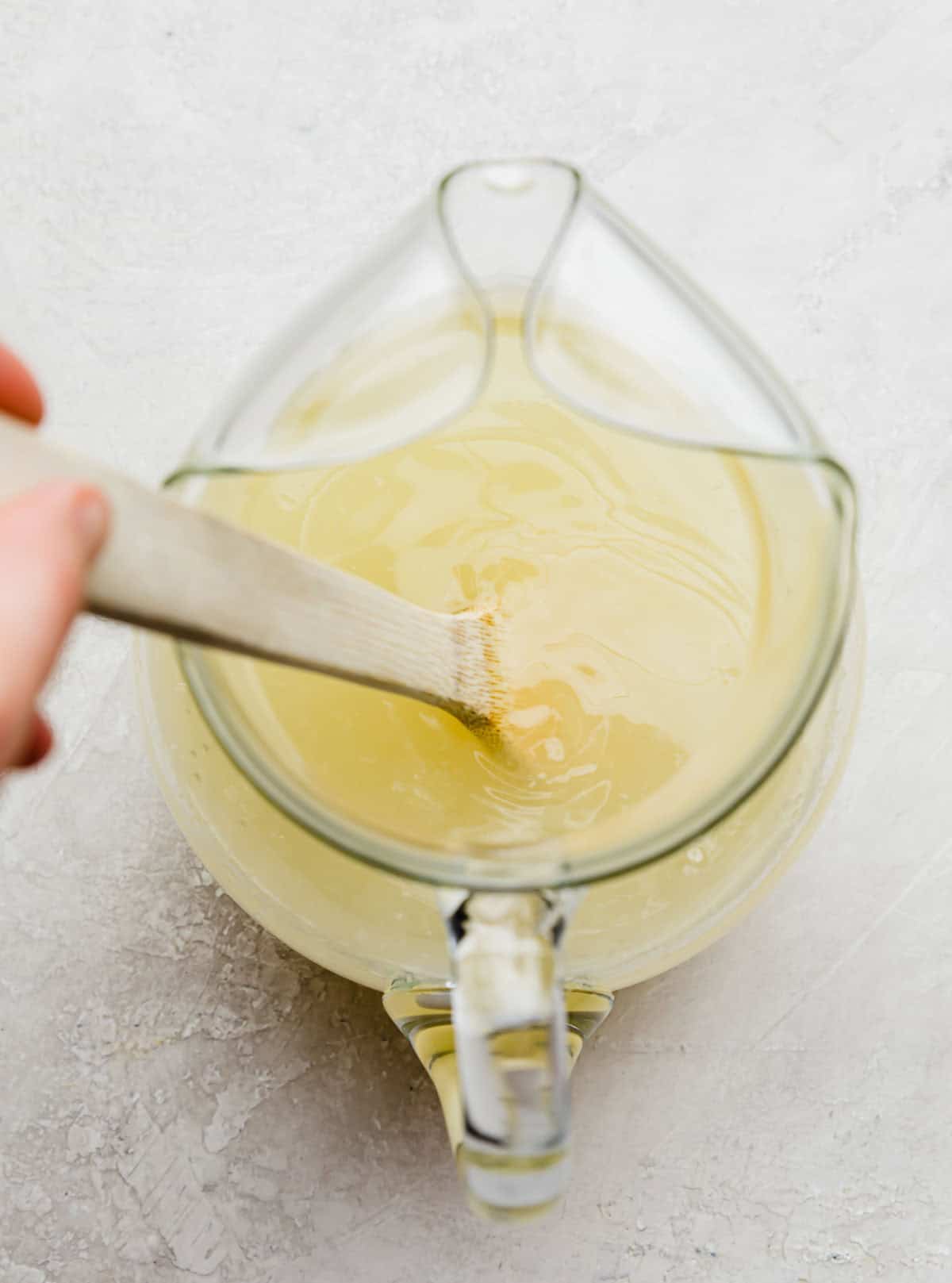 glass pitcher filled with fresh squeezed lemonade.