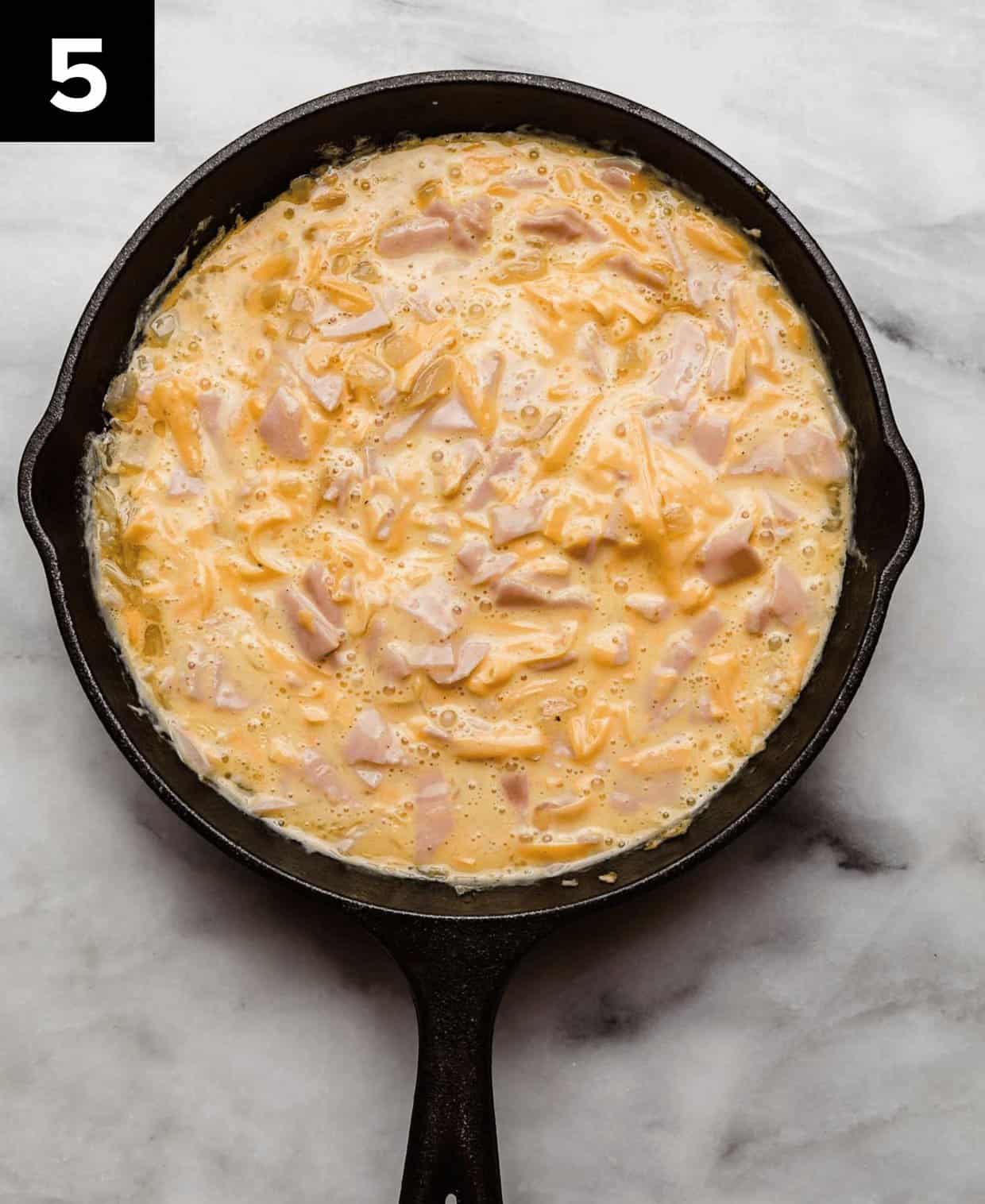 Ham and Cheese Frittata in a cast iron skillet, prior to baking.