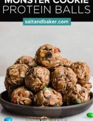 Monster cookie protein bites on a black plate with the words, "Monster Cookie Protein Balls" written in white text above the image.
