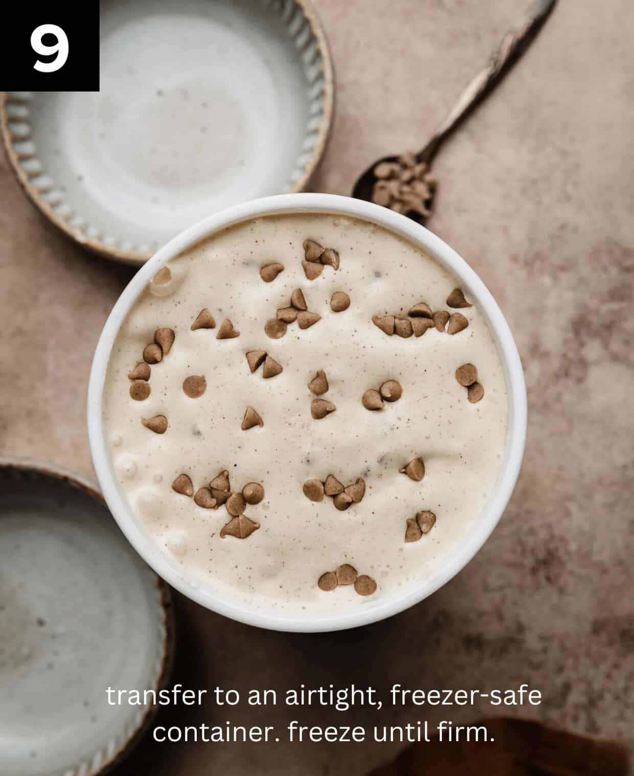 Overhead photo of cinnamon chip ice cream in a round freezer-safe ice cream container on a light brown textured background.