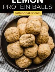 Lemon energy bites on a black plate with the words, "Lemon Protein Balls" written in white text above the image.