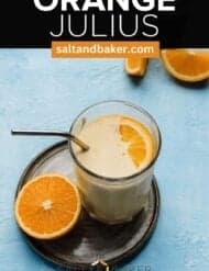A glass cup filled with light orange colored orange Julius smoothie with the words, "Orange Julius" written in white text above the photo.