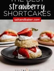 A Classic Strawberry Shortcake on a black plate against a gray background with the words, "The Best Strawberry Shortcakes" written in white text above the photo.