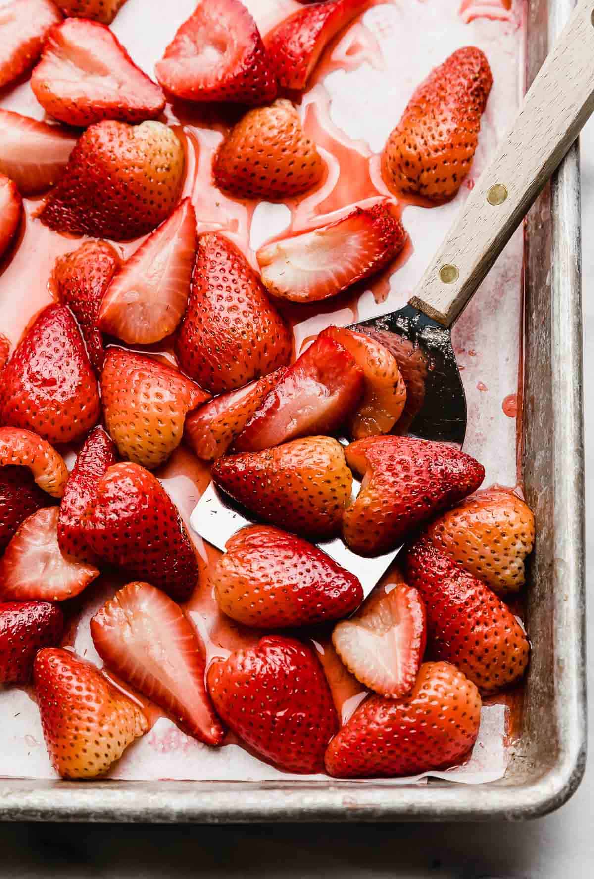Easy Oven baked strawberry halves on a baking sheet.