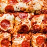 Overhead photo of pepperoni Focaccia Pizza cut into squares.