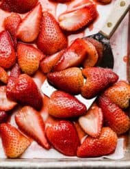 Baked strawberries recipe on a baking sheet.