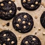 Overhead photo of Peanut Butter Oreo Cookies studded with peanut butter chips on a Kraft parchment paper.
