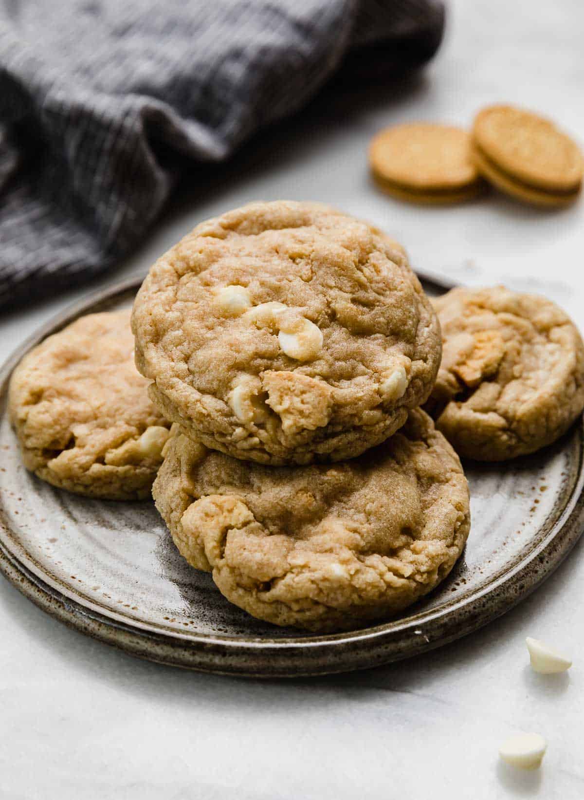 The best Golden Oreo Cookies stacked on a gray plate on a white background.
