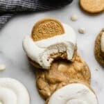 Copycat Crumbl golden oreo cookie recipe topped with white frosting and half of a golden oreo.
