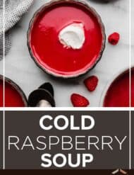 Raspberry soup topped with a dollop of whipped cream on a white marble surface with the words, "Cold Raspberry Soup" written in white text below the photo.