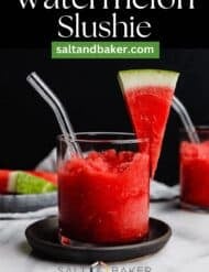 Bright red colored watermelon slushie in a glass cup against a black background with the words, "Watermelon Slushie" written in white text above the photo.
