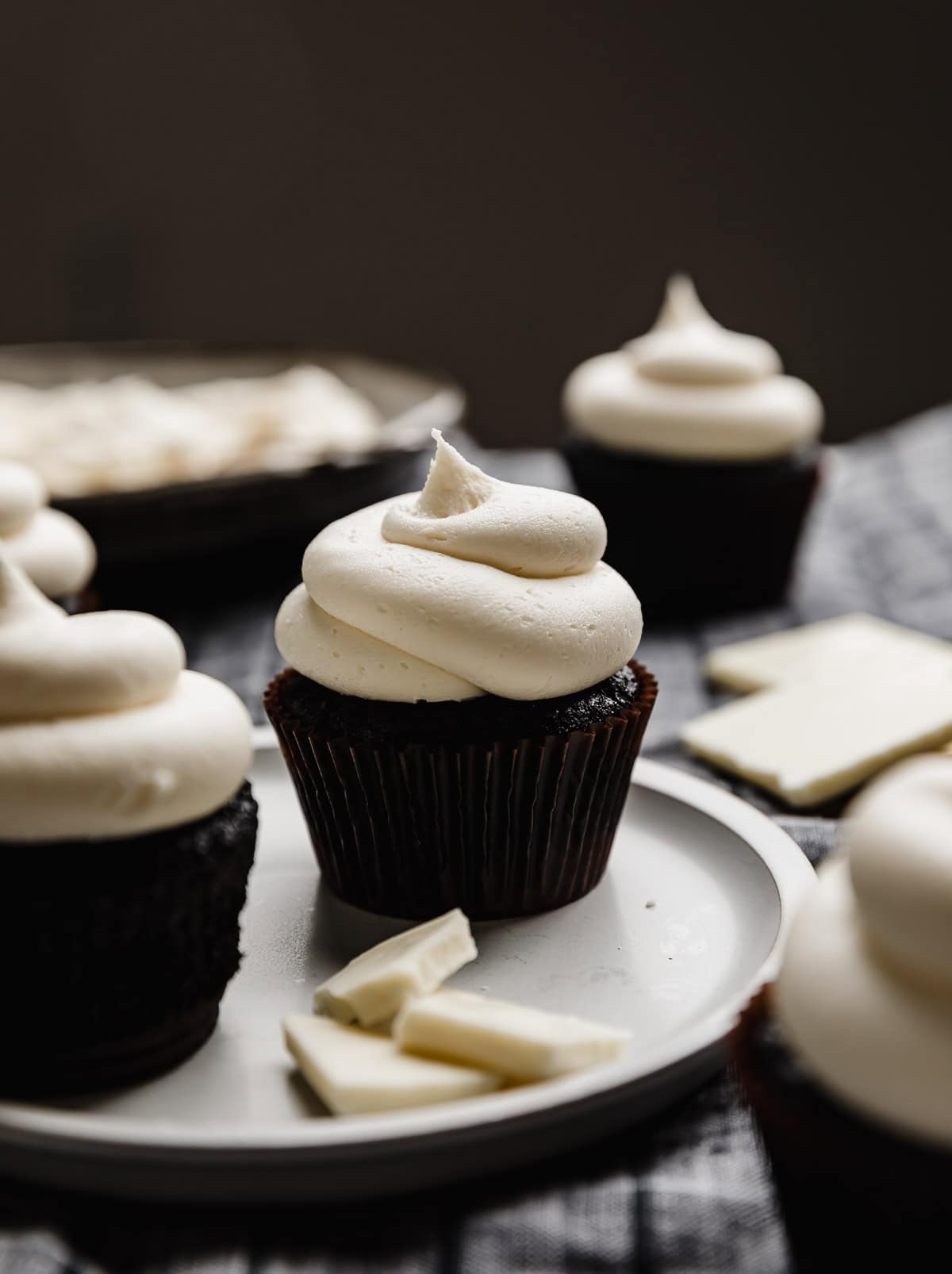 White Chocolate Buttercream Frosting swirled on top of a black velvet cupcake.