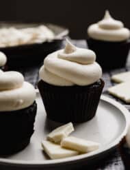 White Chocolate Buttercream Frosting recipe swirled on top of an oreo cupcake.