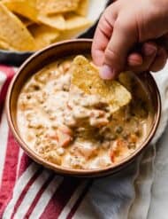 Cream Cheese Rotel and Sausage Dip in a brown bowl.